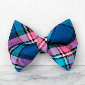 Plaid bow tie with blue, pink, and black pattern on a white background