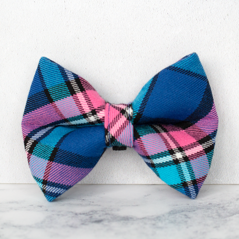 Plaid bow tie with blue, pink, and black pattern on a white background