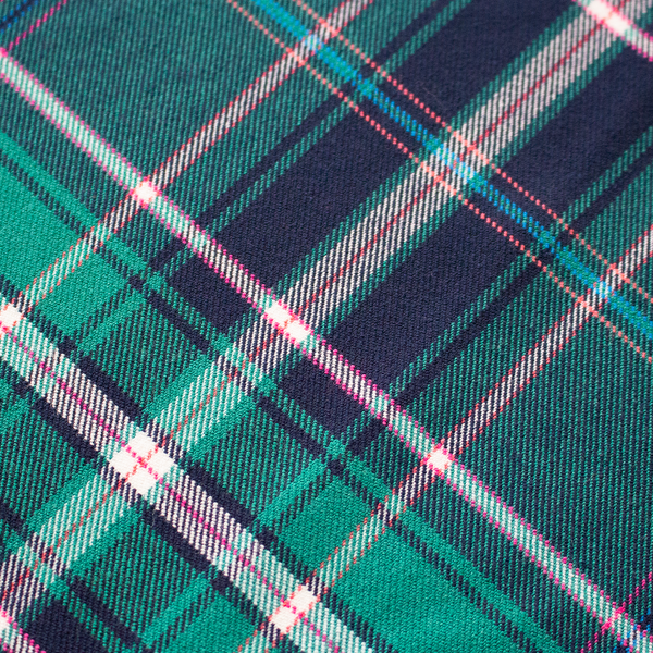 Close-up of a plaid fabric with green, pink, and blue colors.